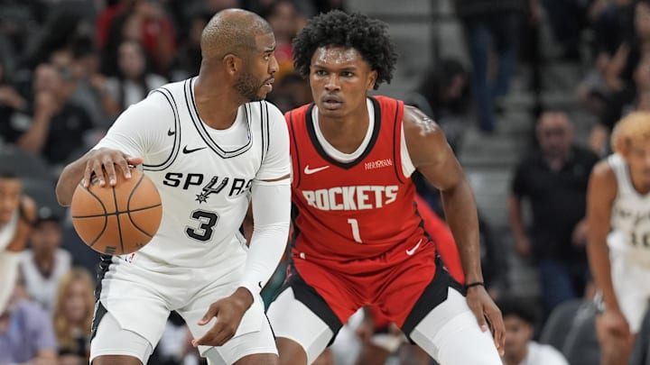 Oct 26, 2024; San Antonio, Texas, USA;  San Antonio Spurs guard Chris Paul (3) dribbles against Houston Rockets forward Amen Thompson (1) in the first half at Frost Bank Center. Mandatory Credit: Daniel Dunn-Imagn Images