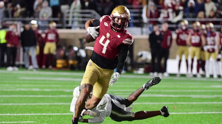 Nov 15, 2025; Chestnut Hill, Massachusetts, USA; Boston College Eagles wide receiver Reed Harris (4) eludes a tackle of a Georgia Tech Yellow Jackets defender during the second half at Alumni Stadium. Mandatory Credit: Bob DeChiara-Imagn Images