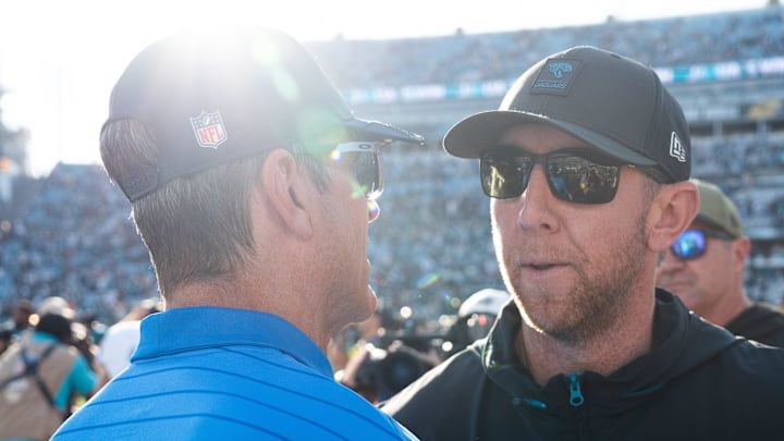 Los Angeles Chargers head coach Jim Harbaugh, left, meets Jacksonville Jaguars head coach Liam Coen after the game in an NFL football game at EverBank Stadium, Sunday, November 16, 2025, in Jacksonville, Fla. The Jaguars defeated the Charger 35-6. [Doug Engle/Florida Times-Union]