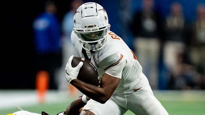 Texas Longhorns wide receiver Matthew Golden (2) evades a tackle from Arizona State Sun Devils defensive back Shamari Simmons (7) in the fourth quarter as the Texas Longhorns play the Arizona State Sun Devils in the Peach Bowl College Football Playoff quarterfinal at Mercedes-Benz Stadium in Atlanta, Georgia, Jan. 1, 2025.
