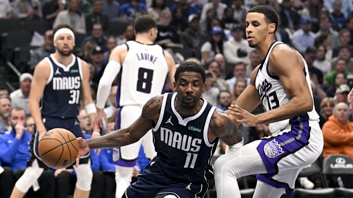 Mar 3, 2025; Dallas, Texas, USA; Dallas Mavericks guard Kyrie Irving (11) drives to the basket past Sacramento Kings forward Keegan Murray (13) during the first quarter at the American Airlines Center. Mandatory Credit: Jerome Miron-Imagn Images