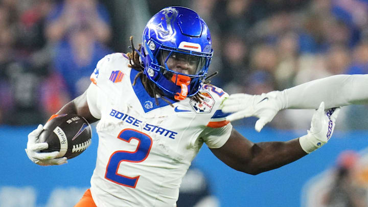 Boise State Broncos running back Ashton Jeanty (2) runs past Penn State Nittany Lions linebacker Kobe King (41) during their Vrbo Fiesta Bowl matchup at State Farm Stadium on Dec. 31, 2024.