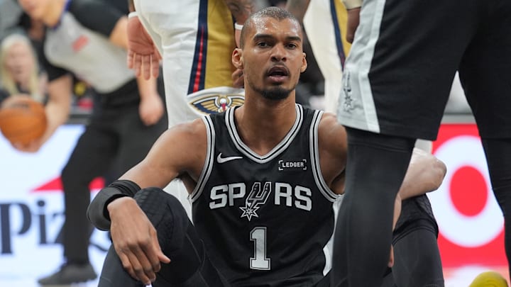 Jan 25, 2026; San Antonio, Texas, USA;  San Antonio Spurs forward Victor Wembanyama (1) sits after getting fouled in the first half against the New Orleans Pelicans at Frost Bank Center. Mandatory Credit: Daniel Dunn-Imagn Images