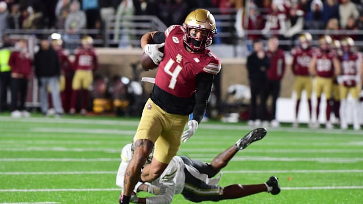 Nov 15, 2025; Chestnut Hill, Massachusetts, USA; Boston College Eagles wide receiver Reed Harris (4) eludes a tackle of a Georgia Tech Yellow Jackets defender during the second half at Alumni Stadium. Mandatory Credit: Bob DeChiara-Imagn Images