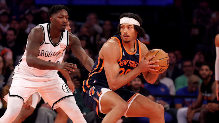 Nov 15, 2024; New York, New York, USA; New York Knicks center Jericho Sims (20) controls the ball against Brooklyn Nets forward Dorian Finney-Smith (28) during the first quarter at Madison Square Garden. Mandatory Credit: Brad Penner-Imagn Images