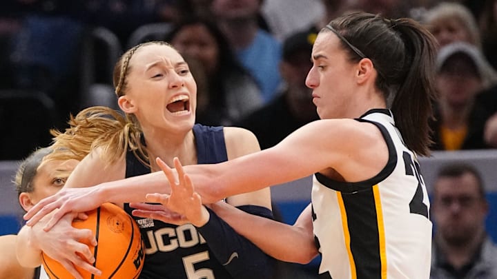 Iowa Hawkeyes guard Caitlin Clark (22) is called for a foul on UConn Huskies guard Paige Bueckers (5) during the Final Four round of the NCAA Women's Basketball Tournament between Iowa and UConn at Rocket Mortgage Fieldhouse, Friday, April 5, 2024 in Cleveland.