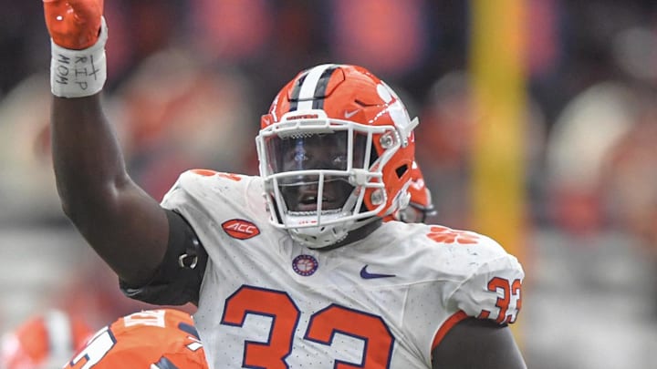 Sep 30, 2023; Syracuse, New York, USA; Clemson defensive tackle Ruke Orhorhoro (33) celebrates sacking Syracuse quarterback Garrett Shrader (6) during the third quarter at JMA Wireless Dome. Mandatory Credit: Ken Ruinard-Imagn Images