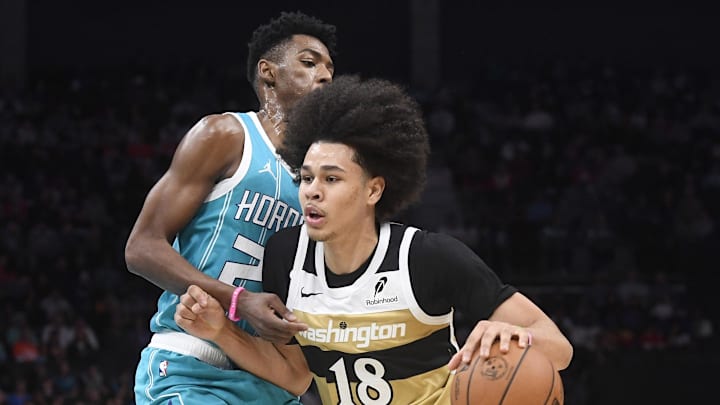 Dec 23, 2025; Charlotte, North Carolina, USA; Washington Wizards guard Kyshawn George (18) drives past Charlotte Hornets guard Brandon Miller (24) during the first half at the Spectrum Center. Mandatory Credit: Sam Sharpe-Imagn Images Dec 23, 2025; Charlotte, North Carolina, USA; Washington Wizards guard Kyshawn George (18) drives past Charlotte Hornets guard Brandon Miller (24) during the first half at the Spectrum Center. Mandatory Credit: Sam Sharpe-Imagn Images