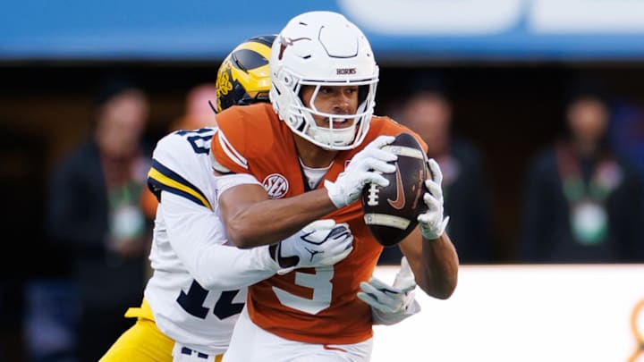 Michigan Wolverines defensive back Zeke Berry  tackles Texas Longhorns wide receiver Emmett Mosley V during the first half at Camping World Stadium. 