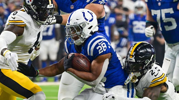 Sep 29, 2024; Indianapolis, Indiana, USA; Indianapolis Colts running back Jonathan Taylor (28) is tackled by Pittsburgh Steelers safety DeShon Elliott (25) during the first quarter at Lucas Oil Stadium. Mandatory Credit: Marc Lebryk-Imagn Images