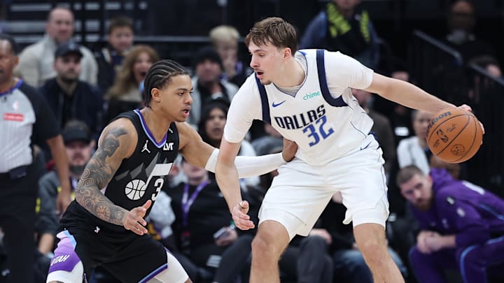 Dec 15, 2025; Salt Lake City, Utah, USA; Dallas Mavericks forward Cooper Flagg (32) controls the ball as Utah Jazz guard Keyonte George (3) defends during the second half at Delta Center. Mandatory Credit: Rob Gray-Imagn Images