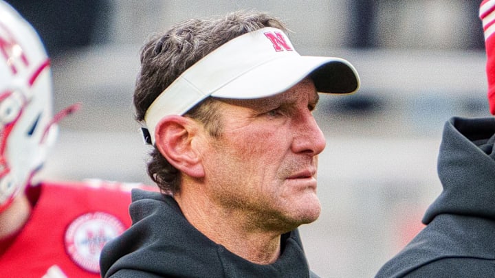 Nov 28, 2025; Lincoln, Nebraska, USA; Nebraska Cornhuskers assistant coach Mike Ekeler (left) watches warmups before the game against the Iowa Hawkeyes at Memorial Stadium. Mandatory Credit: Dylan Widger-Imagn Images