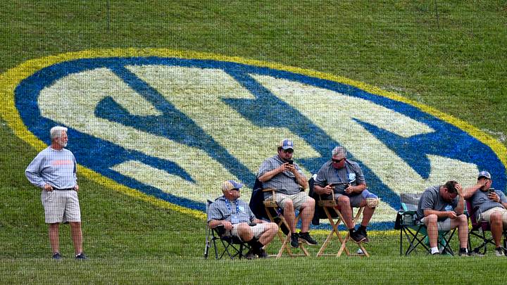 Members of the ground crew watch the LSU vs South Carolina game from a perch in front of a giant SEC logo during the second round of the SEC Baseball Tournament at the Hoover Met Wednesday, May 24, 2023.