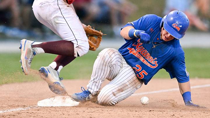 Falmouth third baseman Colby Halter avoids the slide as Jacob Campbell of Hyannis slides safely into third on July 8, 2022. Falmouth third baseman Colby Halter avoids the slide as Jacob Campbell of Hyannis slides safely into third on July 8, 2022.