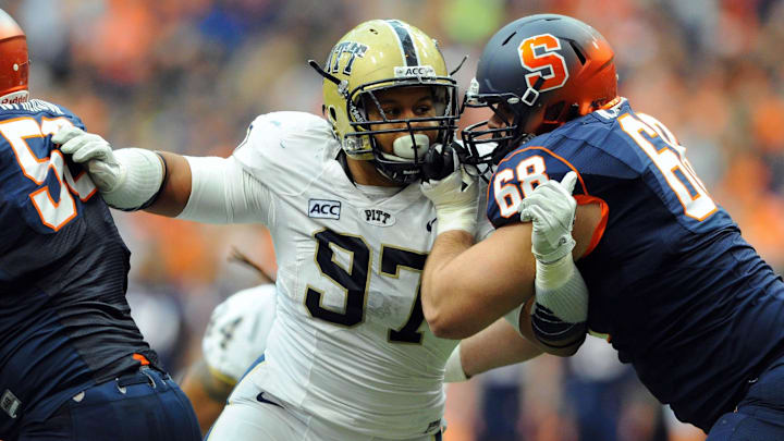 Nov 23, 2013; Syracuse, NY, USA; Pittsburgh Panthers defensive lineman Aaron Donald (97) is blocked by Syracuse Orange guard Nick Robinson (68) during the second quarter at the Carrier Dome.  Mandatory Credit: Rich Barnes-Imagn Images