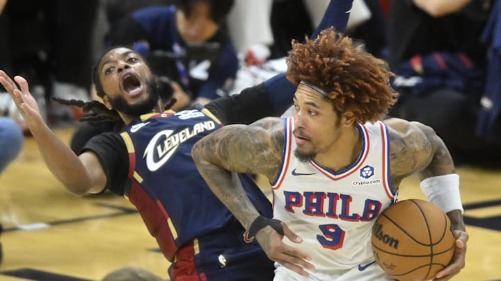Nov 5, 2025; Cleveland, Ohio, USA; Philadelphia 76ers guard Kelly Oubre Jr. (9) backs in to Cleveland Cavaliers guard Darius Garland (10) in the fourth quarter at Rocket Arena. Mandatory Credit: David Richard-Imagn Images