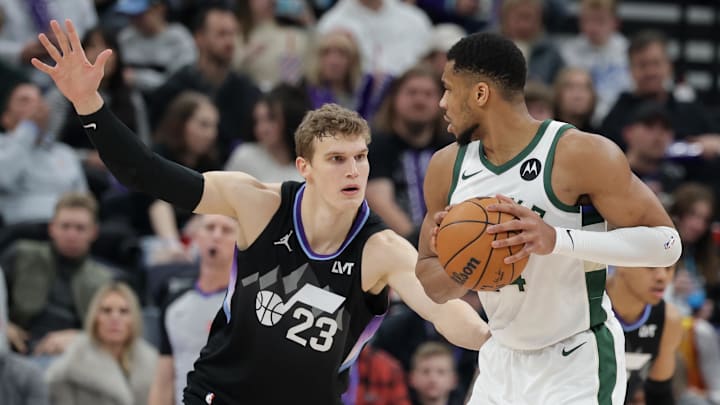 Jan 27, 2025; Salt Lake City, Utah, USA;  Milwaukee Bucks forward Giannis Antetokounmpo (34) keeps the ball away from Utah Jazz forward Lauri Markkanen (23) during the second half at Delta Center. Mandatory Credit: Chris Nicoll-Imagn Images
