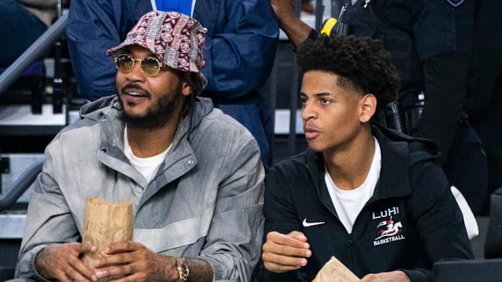 Carmelo Anthony and his son, Kiyan, watch the Don Bosco Prep Ironmen compete against the McEachern Indians in a game during the 50th annual City of Palms Classic at Suncoast Credit Union Arena in Fort Myers on Tuesday, Dec. 19, 2023. Kiyan Anthony and the Long Island Luthern Crusaders defeated Westminster Academy earlier in the day. Carmelo Anthony and his son, Kiyan, watch the Don Bosco Prep Ironmen compete against the McEachern Indians in a game during the 50th annual City of Palms Classic at Suncoast Credit Union Arena in Fort Myers on Tuesday, Dec. 19, 2023. Kiyan Anthony and the Long Island Luthern Crusaders defeated Westminster Academy earlier in the day.
