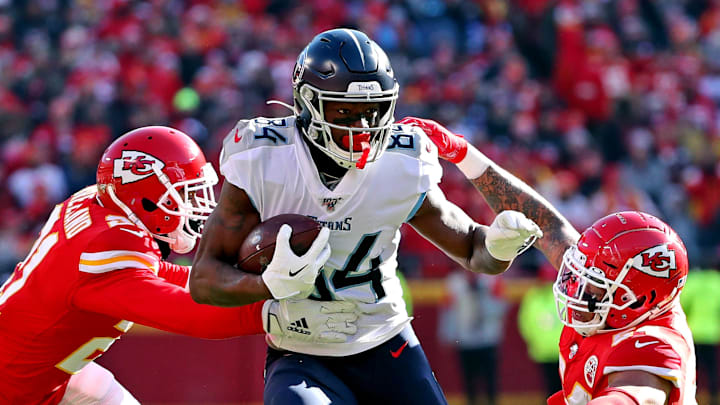Jan 19, 2020; Kansas City, Missouri, USA; Tennessee Titans wide receiver Corey Davis (84) runs the ball against Kansas City Chiefs outside linebacker Damien Wilson (54) during the first quarter in the AFC Championship Game at Arrowhead Stadium. Mandatory Credit: Jay Biggerstaff-Imagn Images