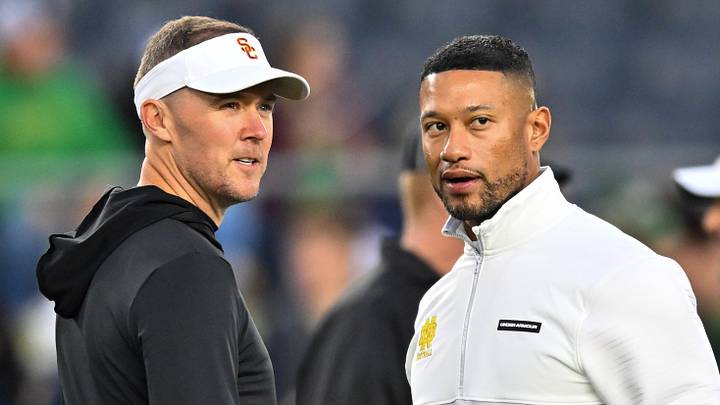Oct 14, 2023; South Bend, Indiana, USA; USC Trojans head coach Lincoln Riley and Notre Dame Fighting Irish head coach Marcus Freeman chat before the game at Notre Dame Stadium. Mandatory Credit: Matt Cashore-Imagn Images