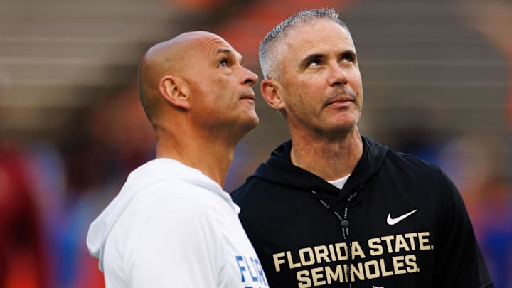 Nov 29, 2025; Gainesville, Florida, USA; Florida Gators interim head coach Billy Gonzales and Florida State Seminoles head coach Mike Norvell talk before the game at Ben Hill Griffin Stadium. Mandatory Credit: Matt Pendleton-Imagn Images Nov 29, 2025; Gainesville, Florida, USA; Florida Gators interim head coach Billy Gonzales and Florida State Seminoles head coach Mike Norvell talk before the game at Ben Hill Griffin Stadium. Mandatory Credit: Matt Pendleton-Imagn Images