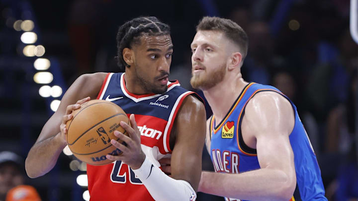 Oct 30, 2025; Oklahoma City, Oklahoma, USA; Washington Wizards center Alex Sarr (20) moves the ball as Oklahoma City Thunder center Isaiah Hartenstein (55) defends during the second half at Paycom Center. Mandatory Credit: Alonzo Adams-Imagn Images