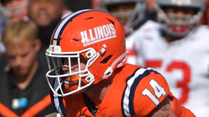 Oct 11, 2025; Champaign, Illinois, USA; Ohio State Buckeyes defensive back Caleb Downs (2) pulls on the jersey of Illinois Fighting Illini tight end Cole Rusk (14) during the second half at Memorial Stadium. Mandatory Credit: Ron Johnson-Imagn Images