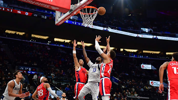 Apr 4, 2025; Inglewood, California, USA; Dallas Mavericks forward Naji Marshall (13) plays for the rebound against Los Angeles Clippers guard Trentyn Flowers (9) and forward Patrick Baldwin Jr. (23) during the second half at Intuit Dome. Mandatory Credit: Gary A. Vasquez-Imagn Images