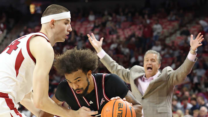 Troy Trojans forward Jackson Fields (15) drives against Arkansas Razorbacks forward Zvonimir Ivisic (44) as coach John Calipari reacts in the first half at Bud Walton Arena.