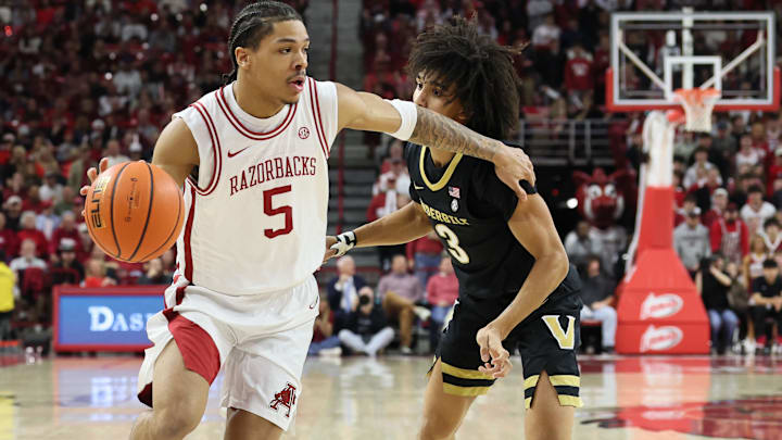 Arkansas guard Darius Acuff, Jr (5) drives against Vanderbilt guard Tyler Tanner (3) during the first half against at Bud Walton Arena. 