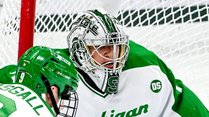 Michigan State's Trey Augustine, right, deflects a Notre Dame shot during the first period on Thursday, Feb. 19, 2026, at the Munn Ice Arena in East Lansing.
