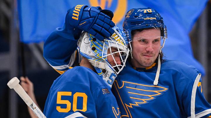 Apr 14, 2026; St. Louis, Missouri, USA; St. Louis Blues center Oskar Sundqvist (70) congratulates goaltender Jordan Binnington (50) after defeating the Pittsburgh Penguins at Enterprise Center. Mandatory Credit: Connor Hamilton-Imagn Images