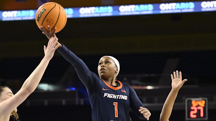 Feb 20, 2025; Los Angeles, California, USA;  Illinois Fighting Illini guard Genesis Bryant (1) drives to the basket between UCLA Bruins guards Elina Aarnisalo (7) and Londynn Jones (3) during the first quarter at Pauley Pavilion presented by Wescom. Mandatory Credit: Robert Hanashiro-Imagn Images