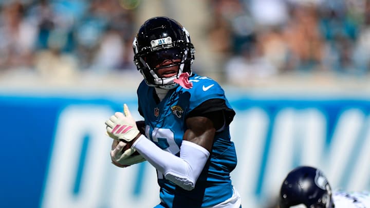 Jacksonville Jaguars wide receiver Travis Hunter (12) rushes for yards against Seattle Seahawks safety Nick Emmanwori (3) during the first quarter of an NFL football matchup, Sunday, Oct. 12, 2025, at EverBank Stadium in Jacksonville, Fla. Jacksonville Jaguars wide receiver Travis Hunter (12) rushes for yards against Seattle Seahawks safety Nick Emmanwori (3) during the first quarter of an NFL football matchup, Sunday, Oct. 12, 2025, at EverBank Stadium in Jacksonville, Fla.
