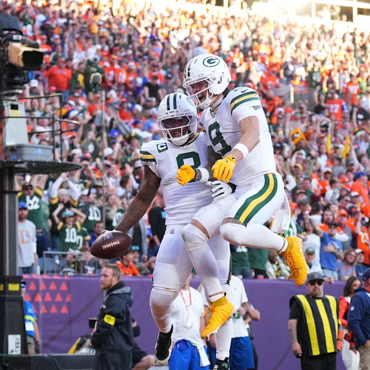 Green Bay Packers running back Josh Jacobs (8) and wide receiver Christian Watson (9) react after Jacobs' touchdown at Denver