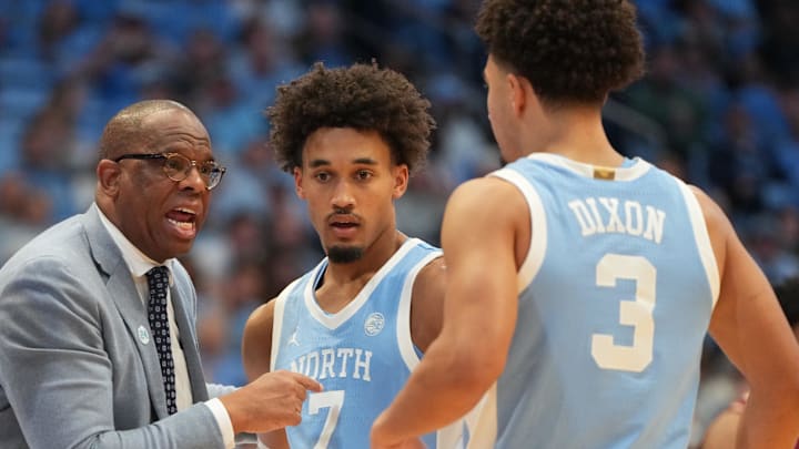 Dec 30, 2025; Chapel Hill, North Carolina, USA; North Carolina Tar Heels head coach Hubert Davis with guard Seth Trimble (7) and guard Derek Dixon (3) in the second half at Dean E. Smith Center. Mandatory Credit: Bob Donnan-Imagn Images