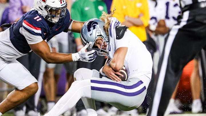 Arizona Wildcats linebacker Jabari Mann tackles Kansas State Wildcats quarterback Avery Johnson. Arizona Wildcats linebacker Jabari Mann tackles Kansas State Wildcats quarterback Avery Johnson.