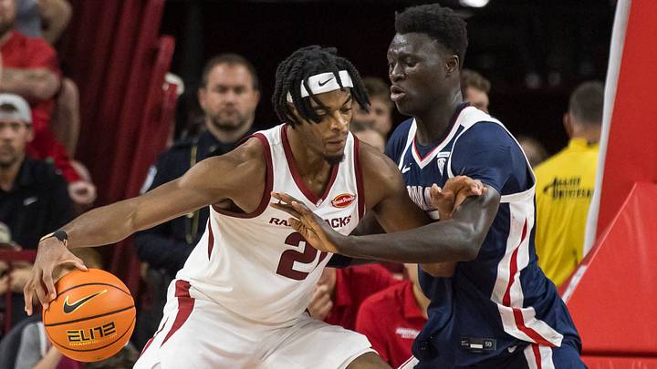 Arkansas Razorbacks forward Cooper Bowser (21) dribbles the ball as Gonzaga Bulldogs center Massamba Diop (35) defends during the second half at Bud Walton Arena.