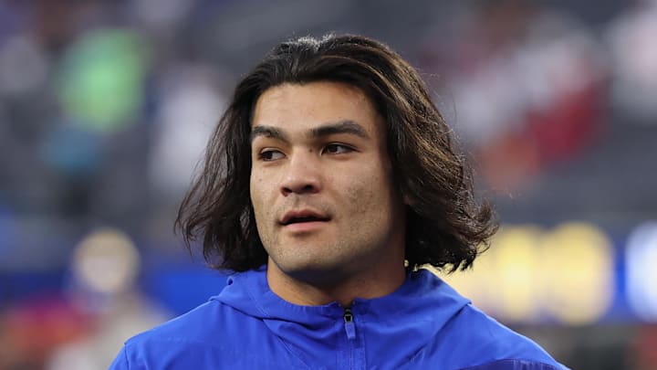 Nov 23, 2025; Inglewood, California, USA; Los Angeles Rams wide receiver Puka Nacua (12) walks on the field holding a mobile phone during warmups before the game against the Tampa Bay Buccaneers at SoFi Stadium. Mandatory Credit: Kiyoshi Mio-Imagn Images