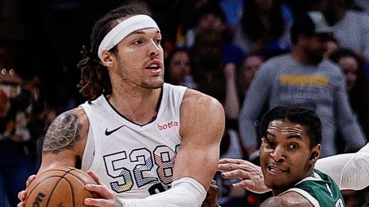 Denver Nuggets forward Aaron Gordon controls the ball under pressure from Milwaukee Bucks guard Kevin Porter Jr.