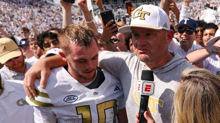 Sep 13, 2025; Atlanta, Georgia, USA; Georgia Tech Yellow Jackets quarterback Haynes King (10) and head coach Brent Key talk to a reporter after a victory over the Clemson Tigers at Bobby Dodd Stadium at Hyundai Field. Mandatory Credit: Brett Davis-Imagn Images