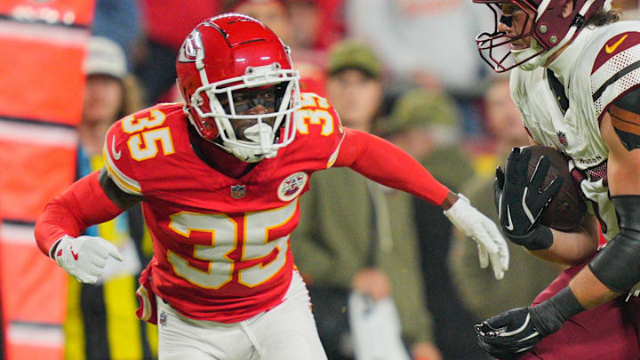 Oct 27, 2025; Kansas City, Missouri, USA; Washington Commanders tight end John Bates (87) carries the ball defended by Kansas City Chiefs cornerback Jaylen Watson (35) during the second quarter of the game at GEHA Field at Arrowhead Stadium. Mandatory Credit: Jay Biggerstaff-Imagn Images