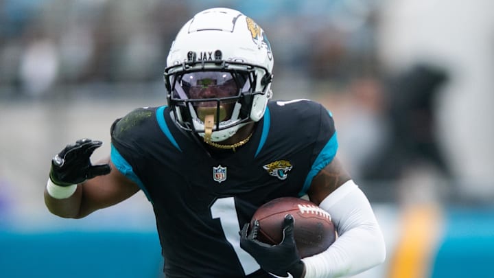 Nov 10, 2024; Jacksonville, Florida, USA; Jacksonville Jaguars running back Travis Etienne Jr (1) runs the ball after the catch agains the Minnesota Vikings in the first quarter at EverBank Stadium. Mandatory Credit: Jeremy Reper-Imagn Images