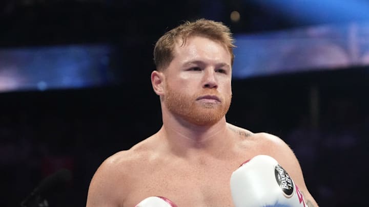 May 7, 2022; Las Vegas, Nevada, USA; Canelo Alvarez (pink trunks) and Dimitry Bivol (black trunks) box during their light heavyweight championship bout at T-Mobile Arena. Mandatory Credit: Joe Camporeale-Imagn Images