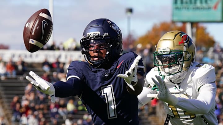 UConn Huskies wide receiver Skyler Bell (1) just misses the catch under pressure from UAB Blazers cornerback Tamarion Crumpley (13) and safety Sirad Bryant (1).