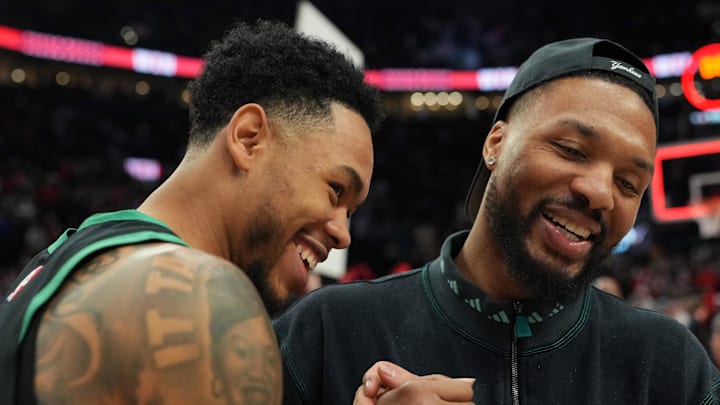 Dec 28, 2025; Portland, Oregon, USA; Boston Celtics guard Anfernee Simons (4) and Portland Trail Blazers guard Damian Lillard (0) meet after the game at Moda Center. Mandatory Credit: Soobum Im-Imagn Images