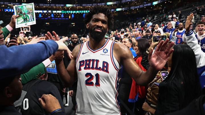 Philadelphia 76ers center Joel Embiid (21) gets congratulated as he leaves the court after their win over the Boston Celtics in game seven of the first round of the 2026 NBA Playoffs at TD Garden. 