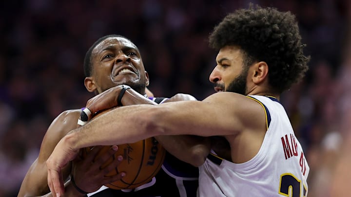 Sacramento Kings guard De'Aaron Fox (5) is fouled by Denver Nuggets guard Jamal Murray (27) during the third quarter at Golden 1 Center.