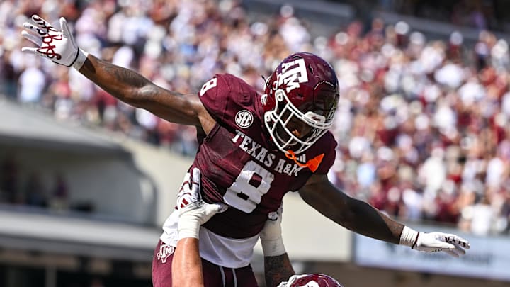Texas A&M Aggies running back Le'Veon Moss (8) celebrates with offensive lineman Chase Bisontis (71) after scoring a touchdown in the second quarter against the Missouri Tigers at Kyle Field.