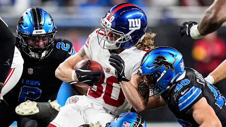 Former Detroit Lions safety Daniel Thomas (2) and LB Jack Campbell (46) tackle Giants returner Gunner Olszewski (80) 